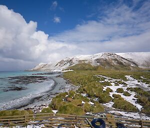 We had a big dump of snow the day after L'Astrolabe arrival. View of the isthmus, eastern part of the escarpment and the east coast. There is extensive snow cover which is in stark contrast with the colours of the vegetation and the ocean