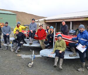 The boating crews and shore crew — preparing for the arrival of L'Astrolabe. They are all standing or sitting on and around the three IRB’s on their trailers