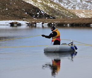 Dominic setting the ropes across the lake from our small inflatable dingy to provide a stable coring platform to work from