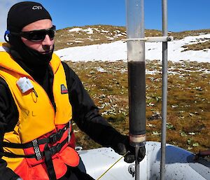 Dominic sits next to a vertical UWITEC surface core from the central point. The flocculent uppermost 12cm of this core most likely represents historical disturbance in the catchment associated with the introduction of non-native animals over the last century or so