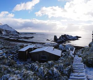 A magical morning at Green Gorge during field training. The image was taken from the path above the hut overlooking the hut, the beach and the coastal escarpment beyond. There is a thick covering of snow