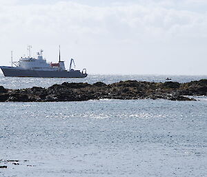 Spirit of Enderby off Sandy Bay. There is a exposed rocky outcrop in the mid-forground and one of the ships IRB’s can be seen making its way across the water