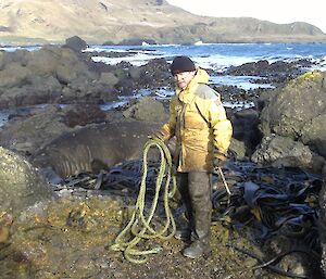 Chris with the final piece of untangled rope. His wet weather gear is covered in slimy brown rotten kelp