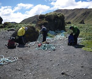 Forward to December; Chris, Josh and Kris load there packs with the rope. Behind them is a big pile of the rest of the rope