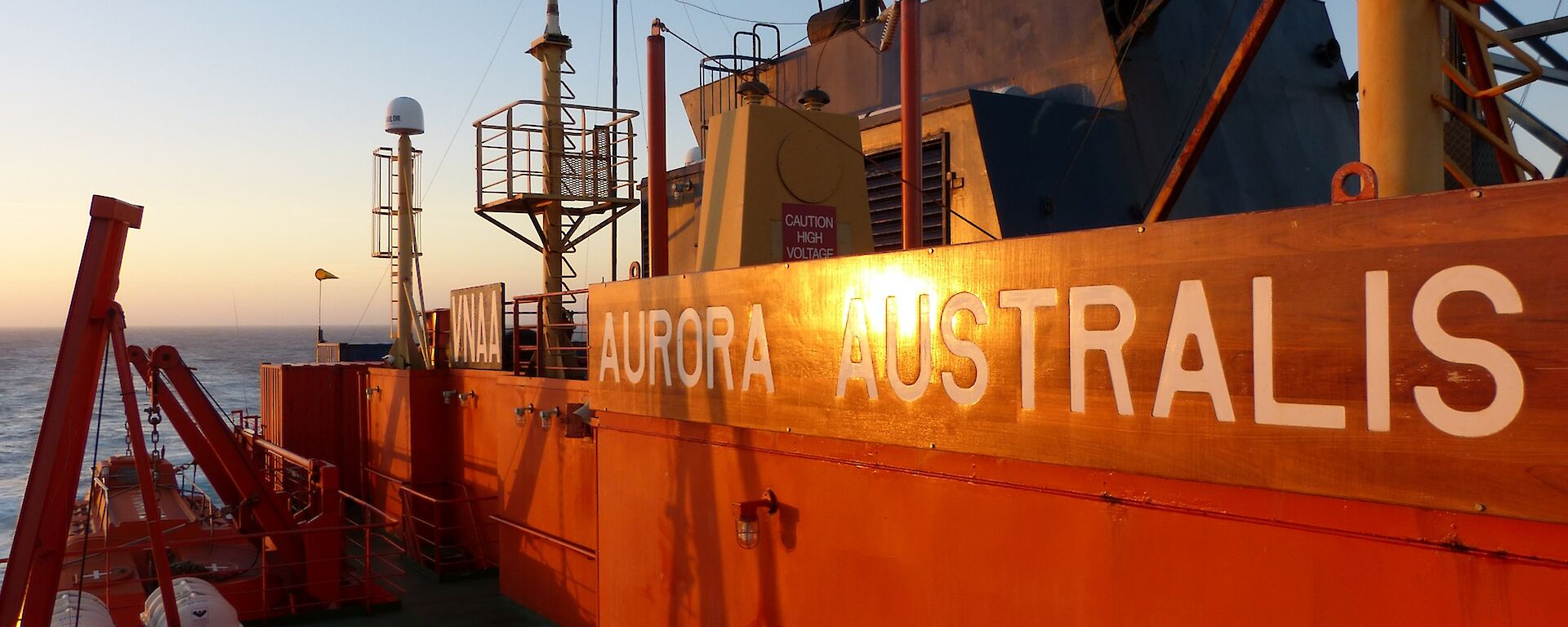 On the Aurora Australia heading to Macquarie Island. On the upper deck the setting sun illuminates the ship’s name