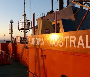 On the Aurora Australia heading to Macquarie Island. On the upper deck the setting sun illuminates the ship’s name
