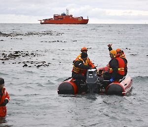 The last IRB trip out to the Aurora Australis (in the background). On board are the watercraft operators, including FTO Marty. A boat handler (Robbie) gives the thumbs up, while standing waist deep in the water