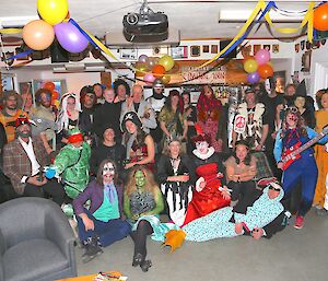 Group photo of expeditoners dressed as heroes and villains for New Years Eve.