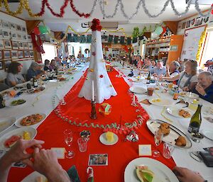 A large table in the mess decorated for the Christmas brunch, seating all 41 expeditioners.