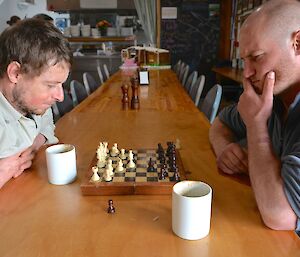 Two expeditioners, Tom and Jack play chess at the mess tables