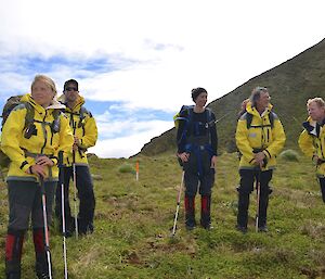 Jaimie, Kris, Kate, Clive and Mike just after arriving at our destination, near Elizabeth and Mary Point. They are standing on the featherbed, carrying their packs and dressed in their wet weather gear