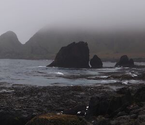 Panoramic view across Soucek Bay, with low cloud and mist seen on the escarpment in the background