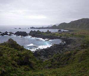 Soucek Bay, looking north across a rock strewn coast and Aurora Point in the distant background