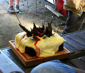 Jimmy’s other cake — a chocolate, raspberry cake covered in a thick layer of lemon icing with slivers of chocolate sticking out of the top