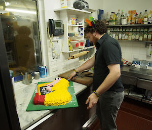 Jimmy puts the finishing touch on Greg’s (Bird) cake. The cake is in the shape of ‘Big Bird’ holding a large eTrex GPS