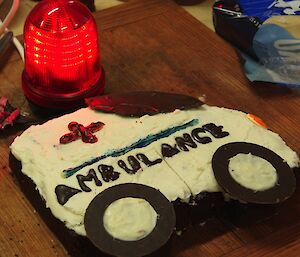 One of Jimmy’s birthday cakes in the shape of a ambulance, complete with a large red flashing light (alongside the cake)