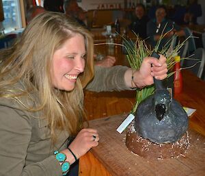 Jaimie cutting her birthday cake. She has stuck the knife in the ‘back’ of the sootie albatross shaped cake