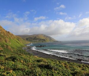 Sandy Bay on the east coast on a sunny day as seen from the grass just near Brothers Point hut