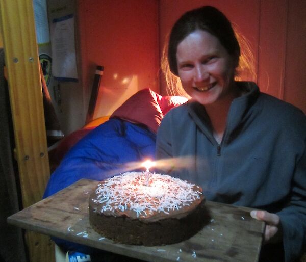 Karen’s birthday cake number one at Bauer Bay hut. The cake has one candle on it