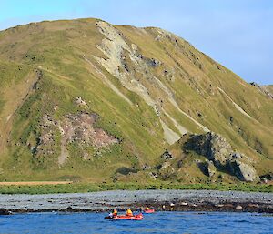 Eagle Bay — Clive and Robbie going ashore. The rock stack that contains Eagle cave and the rugged slopes of the escarpment provide a beautiful backdrop. The image was taken from the third IRB with the second IRB in the foreground and the first IRB close to shore