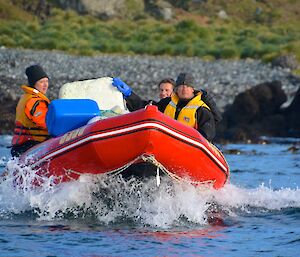 Job well done — the styrofoam block has finally left Eagle Bay. The image is of a close-up of the IRB moving across the water. On board you can see Jesse, Clive and Robbie holding onto the large block of styrofoam and several fishing floats and buoys