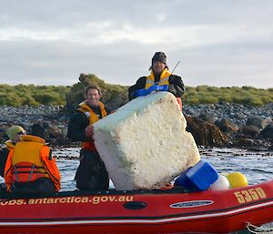 Clive and Robbie are next to the large block of styrofoam in the IRB. Jesse and Mark are also in the boat as well as several fishing floats and buoys that were recovered from Eagle Bay. The pebbly beach and tussock of Eagle Point are in the background