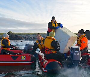 In calm waters offshore from Eagle Point, Clive stands next to the large block of styrofoam to be returned to Australia. Also in the IRB are Robbie, Mark and Jesse. Another IRB can be seen alongside with Jaime and Laura aboard