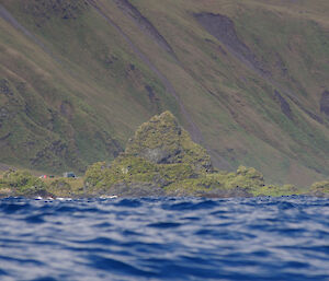 Davis Point hut lies nestled on the coastal flat just below the steep slopes of the west coast escarpment