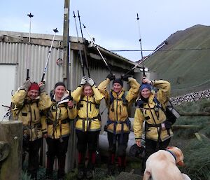 Ange, Leona, Jaimie, Kate and Karen with their walking poles on their heads, being silly before walking back to VJM.