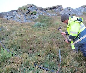 The final touches — Dave fastening the pipe to a star picket to keep it secure