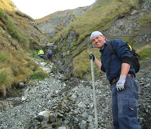 Josh heading up Gadgets Gully with a star picket in hand to secure the water pipe