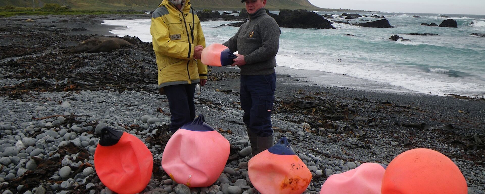 Chris making an honorary donation of a buoy to Greg on West Beach