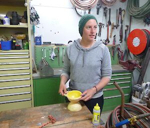 Dana making wool-ball dispenser from buoy in the workshop