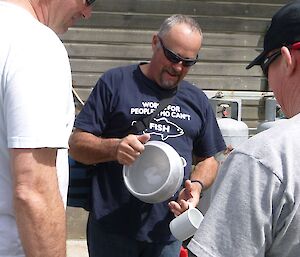 Dave inspecting the aluminium buoy bowl Tom made for him for Christmas