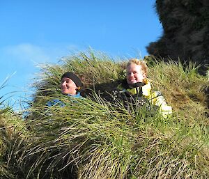 Albatross researcher, Kate, and remediation scientist, Ingrid sitting in the tussock, enjoying the sunshine at Green Gorge