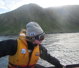 Coxswain and albatross researcher, Jaimie driving the IRB along the east coast of Macquarie