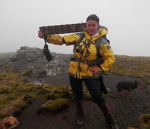 Rodent dog handler, Leona with the Hurd Point sign