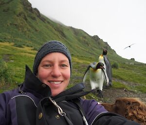 Dog handler, Dana sitting with the King Penguins