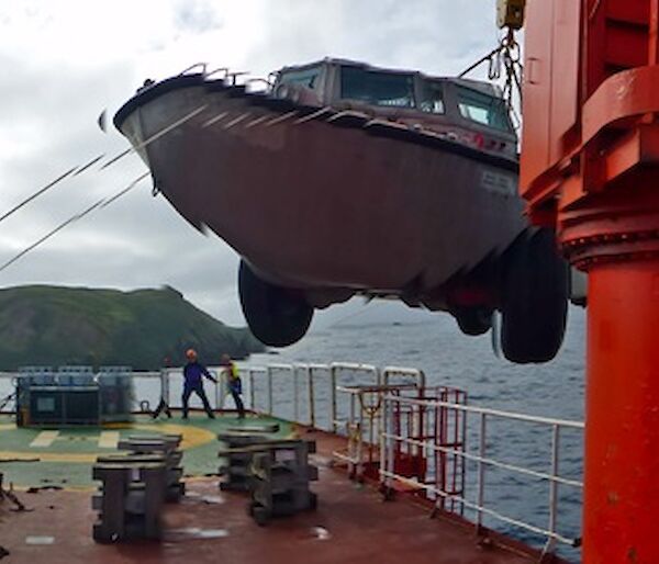 A LARC amphibious truck is unloaded from the ship