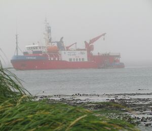 The ship is seen lowering a cargo pallet to the LARC