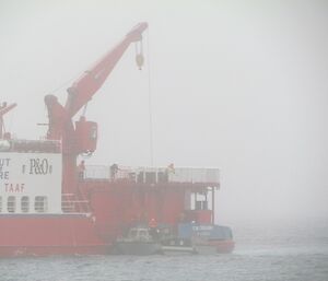 A closer view of the cargo being lowered to the LARC from the ship