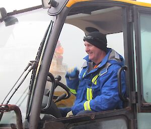 An expeditioner operates the JCB Loadall cargo handler.