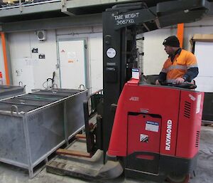 A cargo pallet is being moved in the main store using a forklift