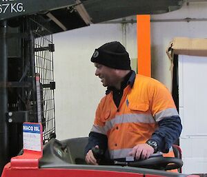 An expeditioner is seen operating the forklift