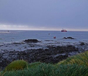 The ship is seen with floating hose to shore for refuelling the station