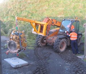 The JCB handler lifts and moves the engine