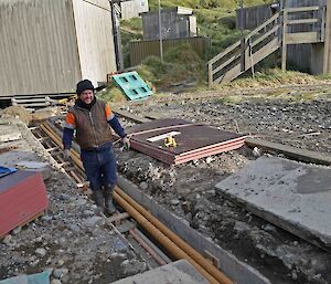 A plumber working in the trench