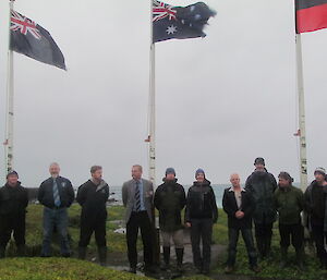 The station group is seen in front of the flags at the mast head