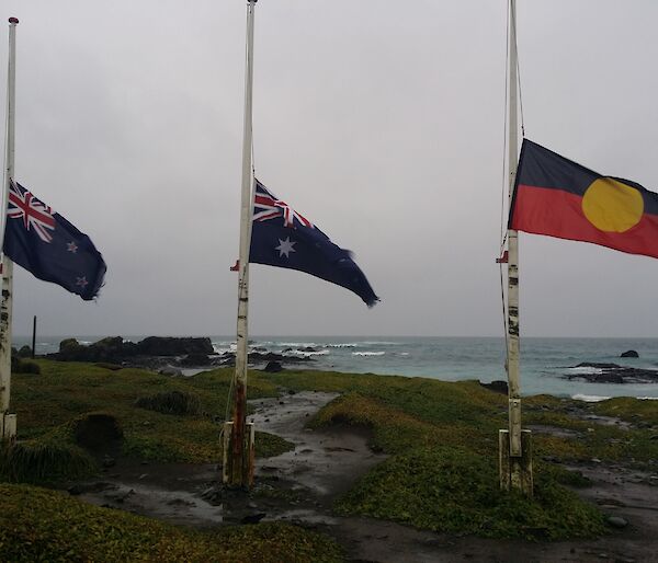 The Australian, New Zealand, and aboriginal flag are seen at half mast