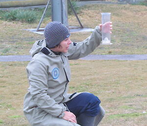 Observer checks rain gauge